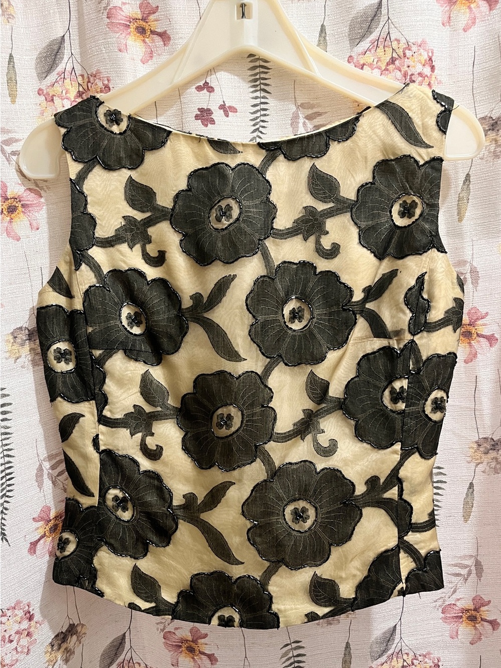 Sleeveless Cream Blouse with Black Floral Appliqué